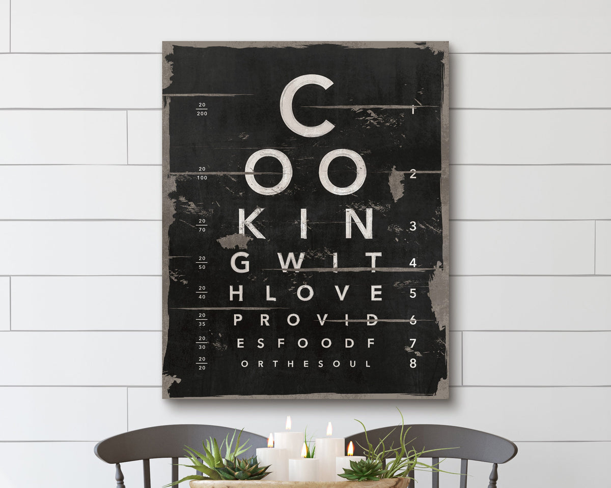 This artwork mimics an eye chart, creatively spelling out "Cooking with love provides food for the soul" in a bold, distressed typography style. The black and white design, with a vintage, rustic texture, adds a charming, modern farmhouse feel to any kitchen or dining space. Perfect for food lovers and home chefs, this unique wall art serves as both an inspiring message and a stylish decor piece, blending typography art with culinary passion.