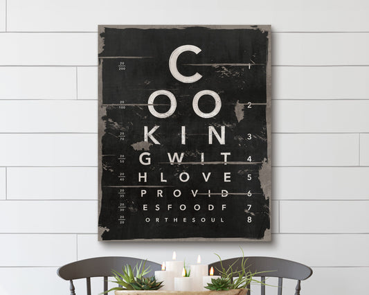 This artwork mimics an eye chart, creatively spelling out "Cooking with love provides food for the soul" in a bold, distressed typography style. The black and white design, with a vintage, rustic texture, adds a charming, modern farmhouse feel to any kitchen or dining space. Perfect for food lovers and home chefs, this unique wall art serves as both an inspiring message and a stylish decor piece, blending typography art with culinary passion.
