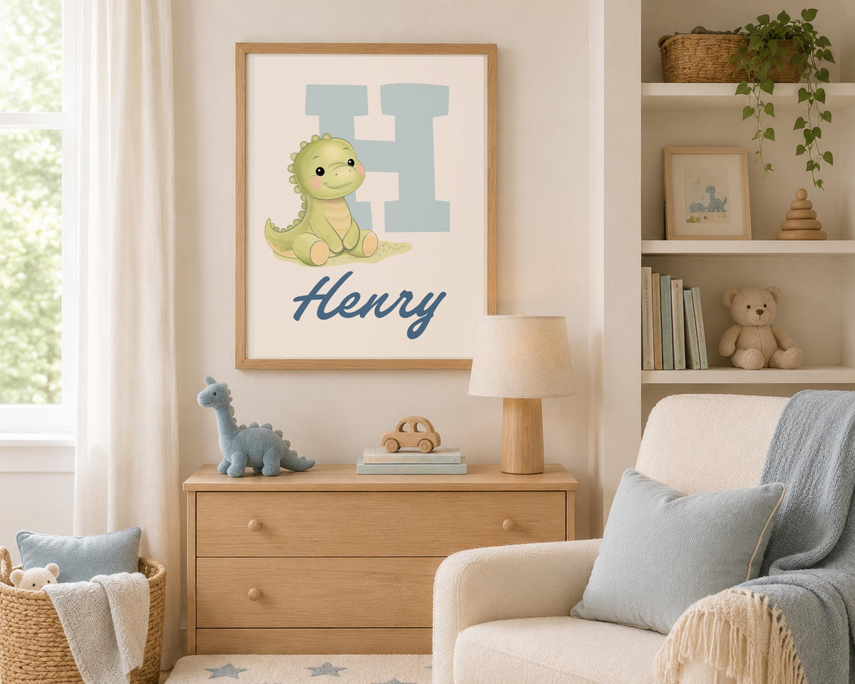 May include: A framed wall print featuring a large light blue letter H, a small green cartoon dinosaur, and the name Henry written in dark blue script. The artwork is displayed in a light wood frame, showcasing a clean and simple design.
