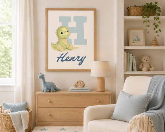May include: A framed wall print featuring a large light blue letter H, a small green cartoon dinosaur, and the name Henry written in dark blue script. The artwork is displayed in a light wood frame, showcasing a clean and simple design.